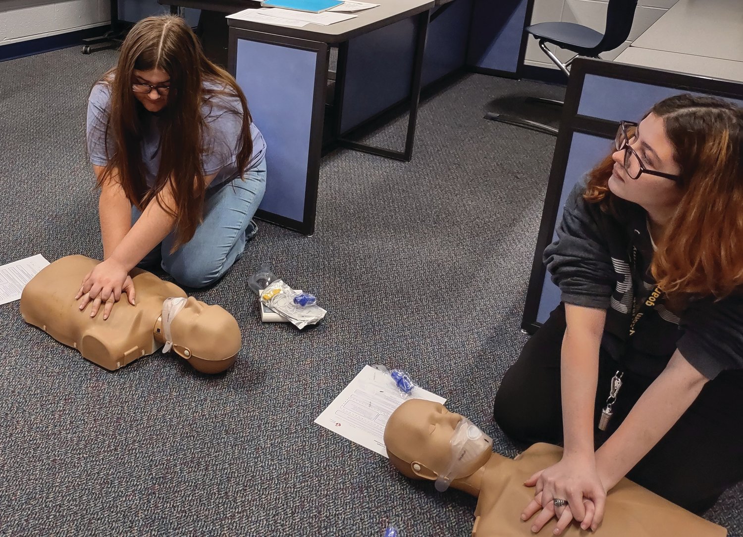 Isabelle Overton and Salena Drummond learn CPR techniques.